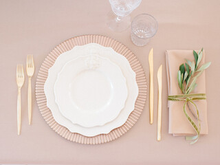 Top View Dishware And Cutlery On Beige Table