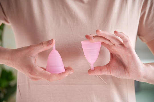 Multi-sized menstrual cups in hand