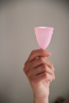  hand holding menstrual cup