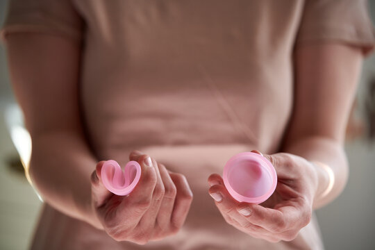 Close-up of hands with menstrual cups