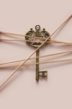 Vintage ornate key tied with golden chain