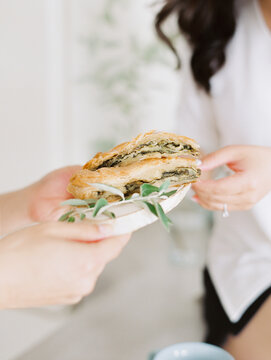 Hands Giving Plate With Sandwich 
