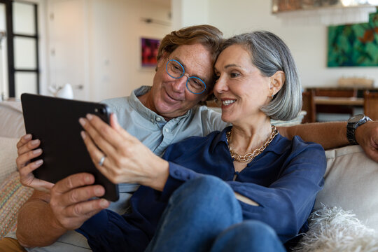 Happy Couple Shares a Tablet