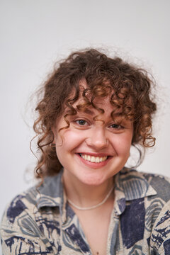 smiling curly girl on white background