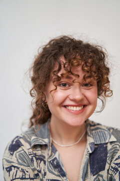 close up of a laughing young woman with curly hair