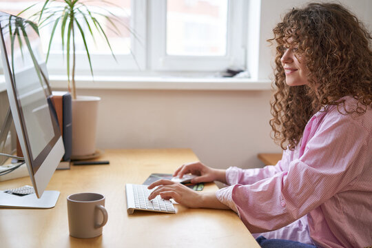 young woman working on a computer from home