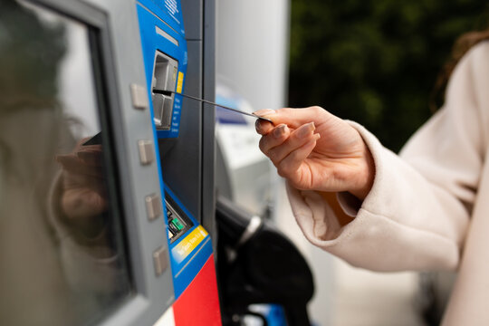 Person Puts Their Card In The Slot At The Gas Pump