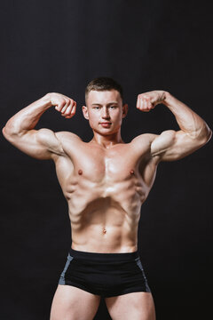 Bodybuilder working out and posing at camera 