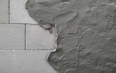 Cement mortar mixed to bond building blocks and coating lightweight concrete wall surface. Plaster...