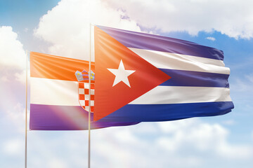 Sunny blue sky and flags of cuba and croatia