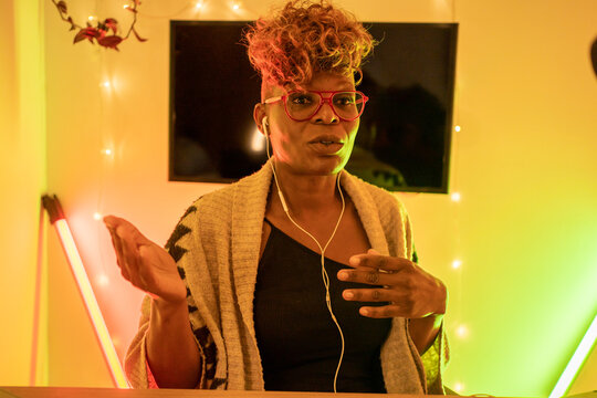 Black Woman Youtuber On A Live With Yellow Lights, Streaming From Home