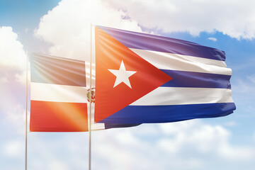 Sunny blue sky and flags of cuba and dominican republic