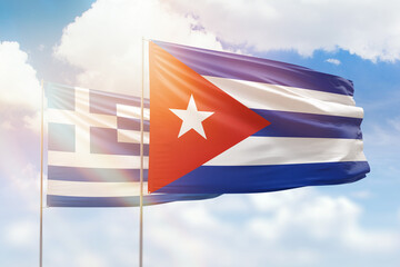 Sunny blue sky and flags of cuba and greece