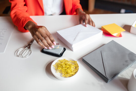 Cropped woman making invitations
