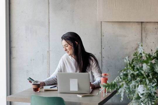 Young Girl Working With Computer in a Cafe