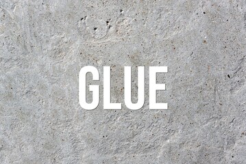 GLUE - word on concrete background. Cement floor, wall.