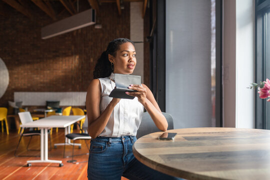 Woman taking notes on checkbook in cowork space