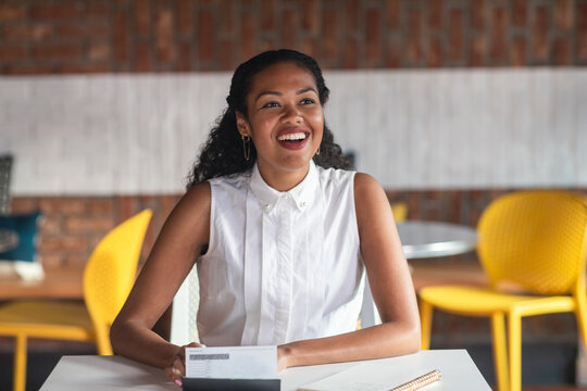 Charismatic project manager in cowork area by checkbook