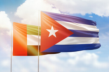 Sunny blue sky and flags of cuba and uae