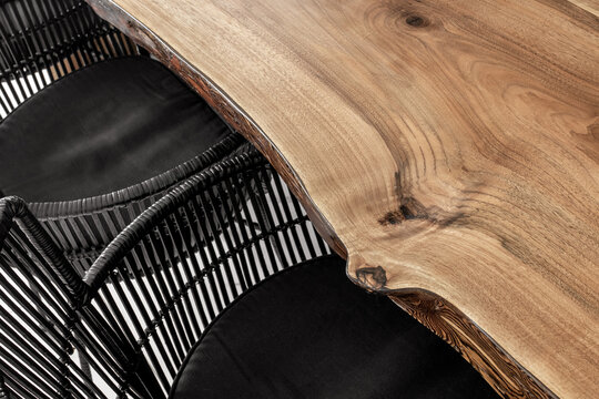 Dark wicker chairs by textured wooden table