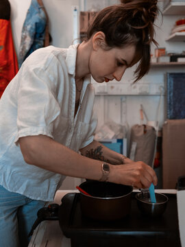 Young Women Work With Hot Wax In Art Studio