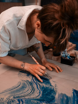 Female artist business woman carving painting close up