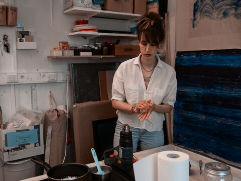 Young Woman Working In Wax Paint Making Business