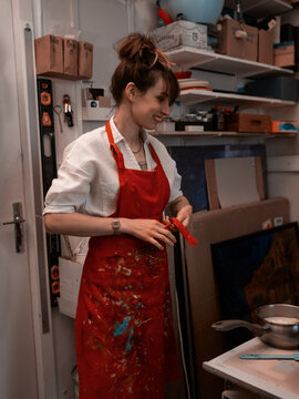Business women tiding up red apron at her workspace