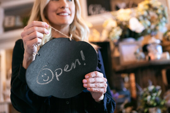 Boutique: Owner Walking To Put Open Sign Out