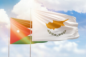 Sunny blue sky and flags of cyprus and jordan