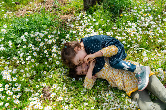 Little friends playing in spring with flowers