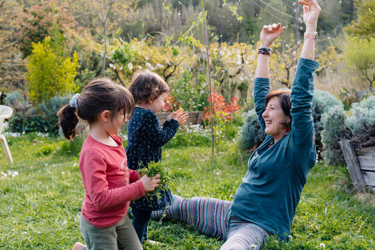 Grandma and granddaughters playing together in nature