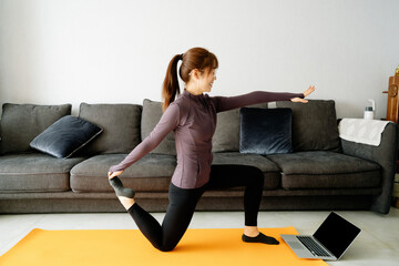 Young Asian girl doing yoga at home