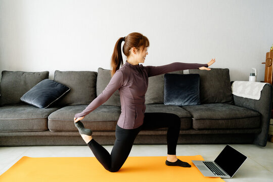Young Asian girl doing yoga at home