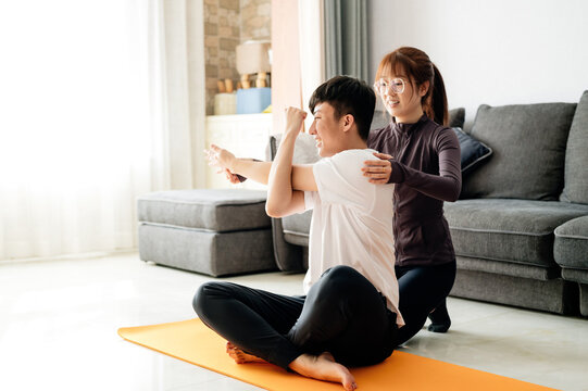 Couple exercising in living room