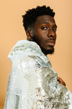 Cool black man studio portrait with sequin jacket