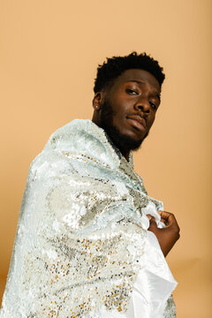 Attractive black man studio portrait with sequin jacket