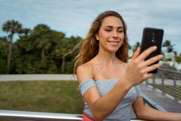 Woman using her mobile phone outdoor 
