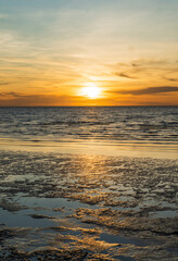 Fototapeta premium Sunset sky clouds vertical over sea in the evening with colorful orange sunlight reflect on the sea landscape with summer travel concept