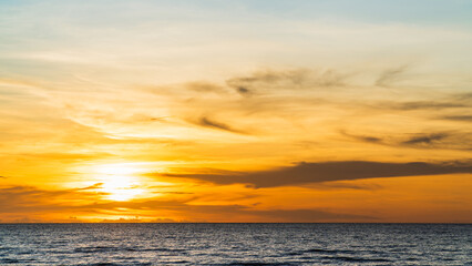 Sunset sky over sea in the evening with orange sunlight, landscape in summer season on seaside beach