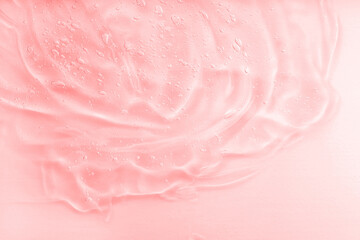 Cosmetic jelly serum texture. Clear collagen gel, moisturizer backdrop. Pink liquid transparent...