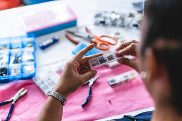 Close-up of a woman making costume jewelry 