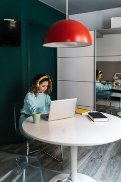 Self employed woman working on netbook at home