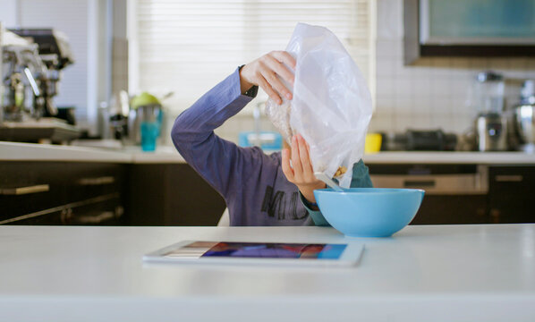 Seven year old boy using a digital tablet 
