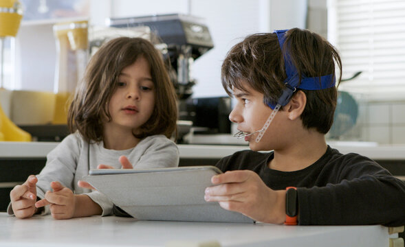 Portrait of kids using a digital tablet