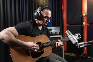 Man Playing Guitar In The Music Studio