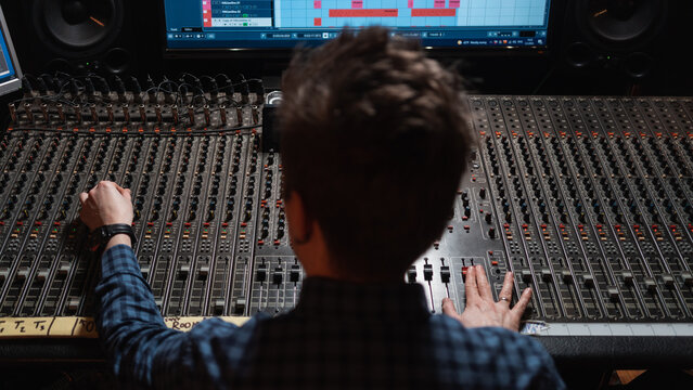 Anonymous Man Working With Equipment In The Music Studio