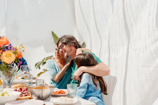 Embraced family having lunch in spring