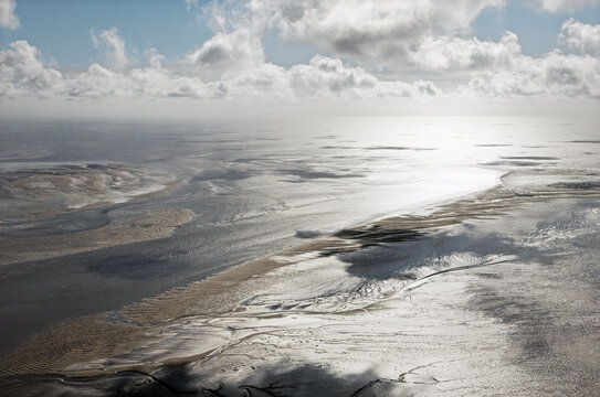 Morecambe Bay showing tidal mudflats northwest of Lancaster, Lancashire, England.  Looking southwest. Aerial.
