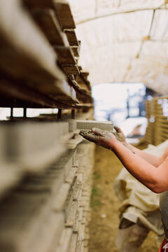Man's hand demolding tiles